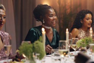 Women, dinner and business people at party with food, drinks and plate for charity drive at night. Group, friends and luxury fine dining for fundraiser with celebration, alcohol or talk at gala event